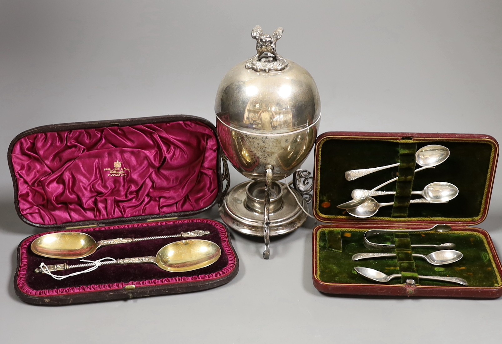 A set of six George V silver teaspoons and tongs, 3oz, a cased pair of Victorian silver gilt apostle serving spoons, 2.9oz and an incomplete plated egg coddler